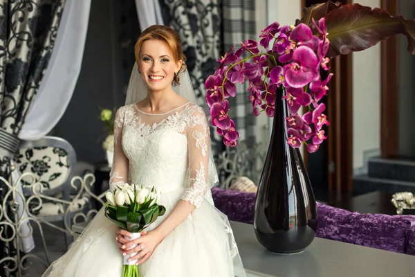 Bride with bouquet in luxury interior