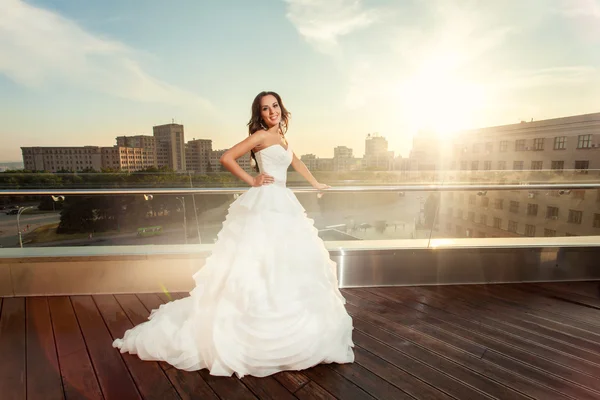 Woman bride in wedding dress and sunset