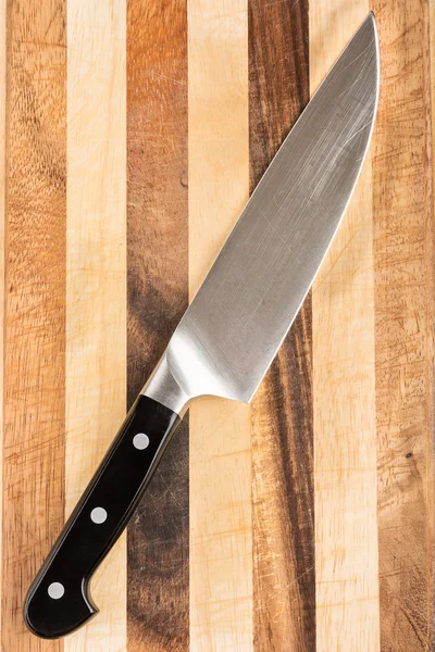 Cook\'s knife on chopping board