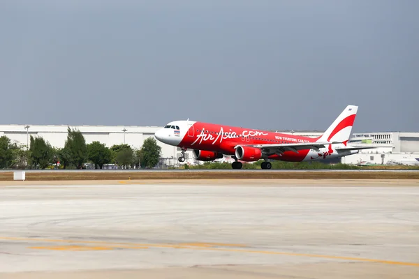 Bangkok,Thailand-January 11,2014: HS-ABF Thai Air asia Airbus a320-216 touching down on runway at Don Mueang International Airport.Thai Air Asia company is one of  low cost airlines in Asia