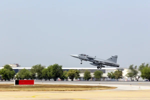 Jet fighter aircraft with landing gear take off from runway with
