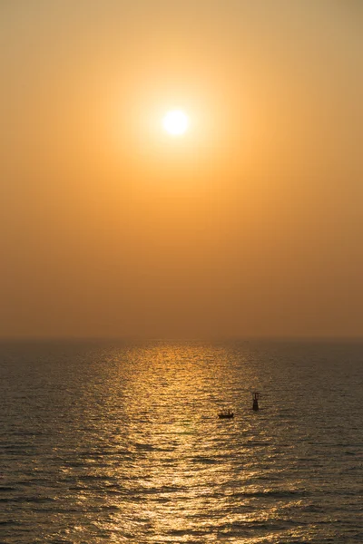 silhouette sunrise at sea with lighthouse and boat in Hua Hin, Thailand