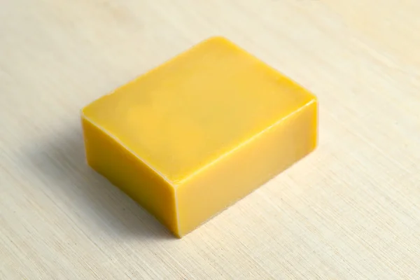 Soap bar flavor with banana ingredient isolated on wooden board