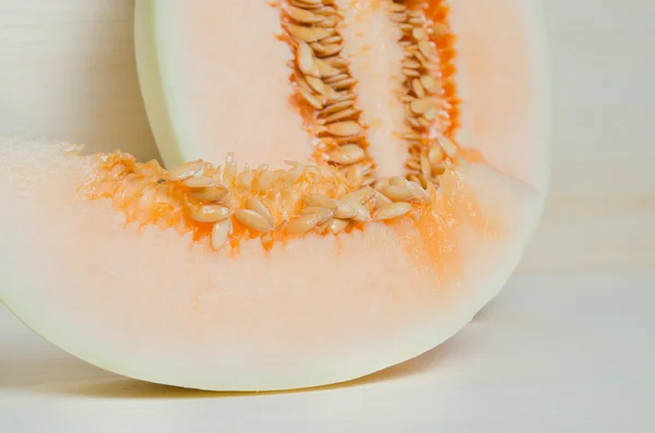 Melon or cantaloupe sliced on wooden board with seeds (Other nam
