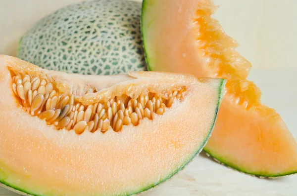 Sliced melon with seed on wooden board (Other names are Melon, c