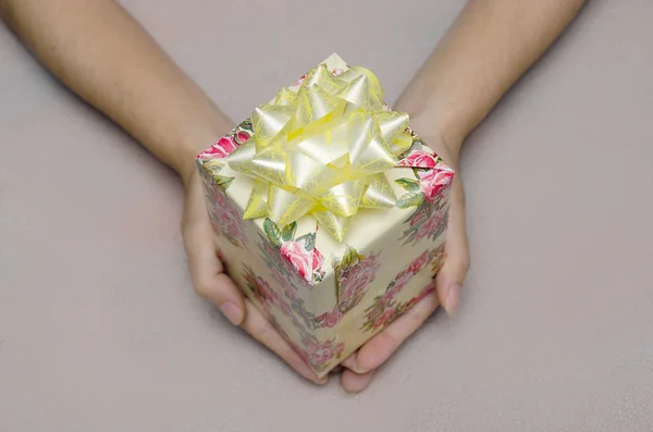 Offer of gift box present with hand holding it, Christmas and ne