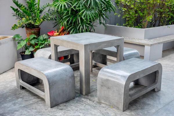 Concrete outdoor furniture set in small garden