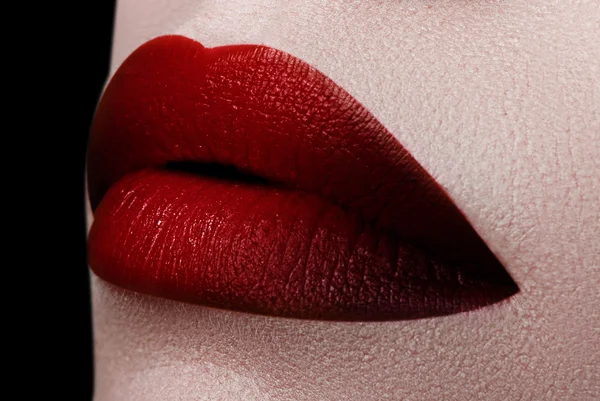 Extreme close up on model with dark red lipstick. Makeup. Professional fashion retro make-up. dark red lipstick. Wine Lips