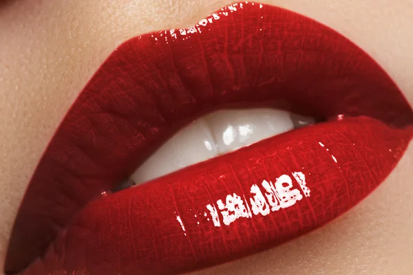 Sexy kiss. Close-up of woman\'s lips with bright fashion dark red glossy makeup. Macro lipgloss cherry make-up.