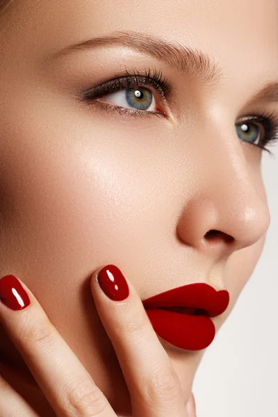 Sexy lips. Beauty red lips makeup detail. Beautiful make-up closeup. Beautiful fashion model girl face. Perfect skin. Make up. Red manicure