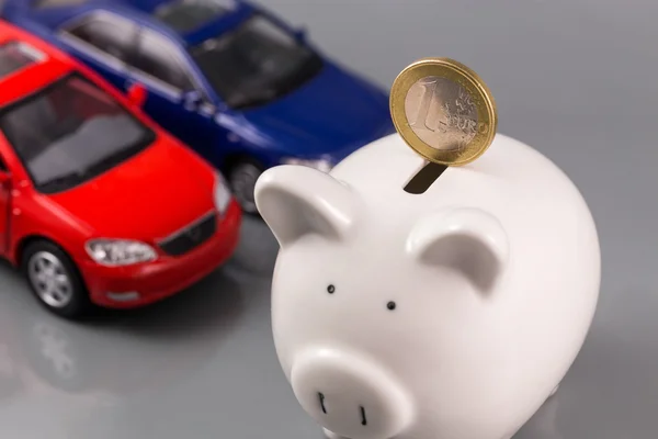 Piggy bank with euro and cars