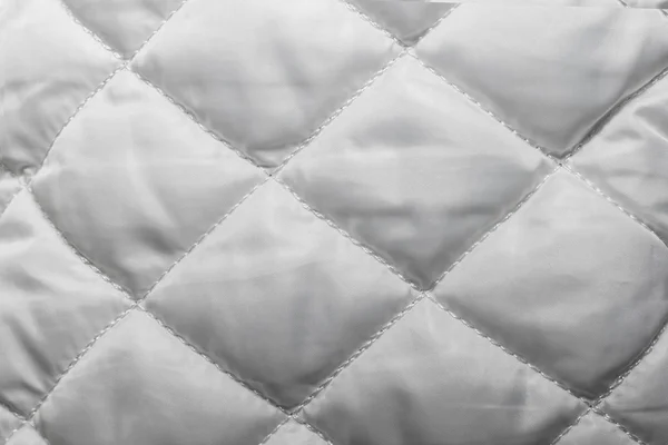 Quilted fabric texture of white color for hammering,