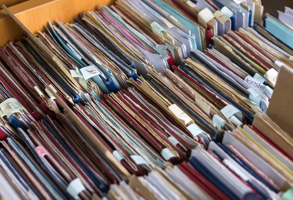 File folders in a file cabinet, card catalog in a library, close