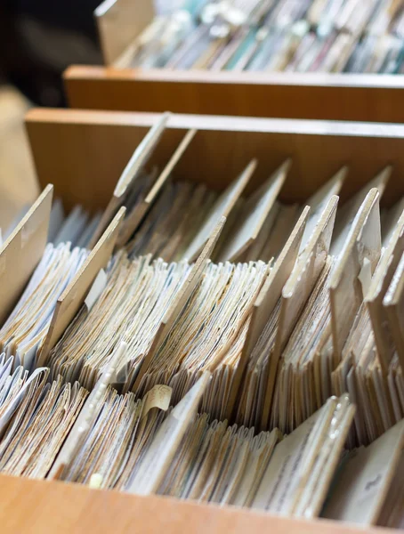 File folders in a file cabinet, card catalog in a library, close