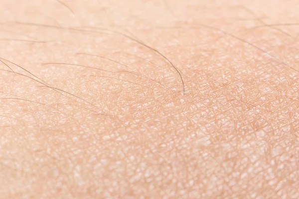 Human skin texture with black hairs soft focus on the skin for h