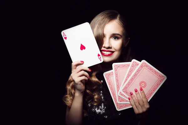 Sexy girl with cards in hands on a black background