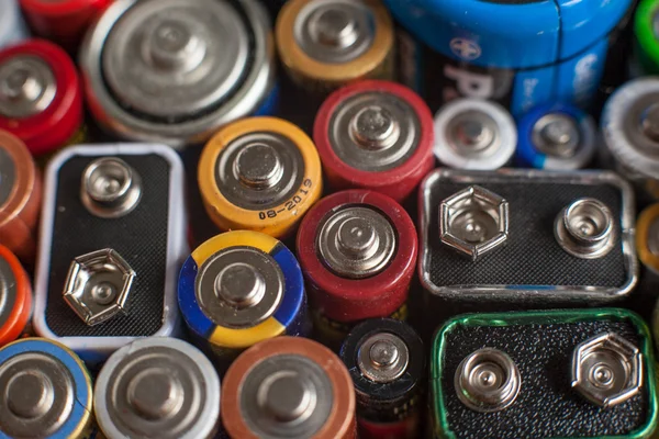 Color batteries of different sizes on a white background isolate