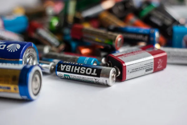 Color batteries of different sizes on a white background isolate