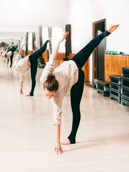 Young woman trains the flexibility