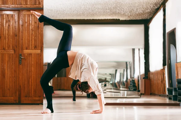 Young woman trains the flexibility