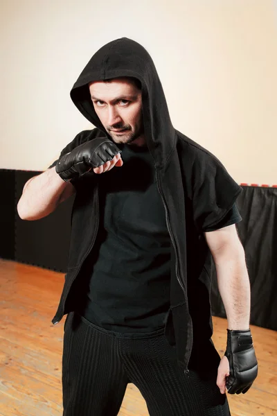Aggressive street fighter in black sport cloth