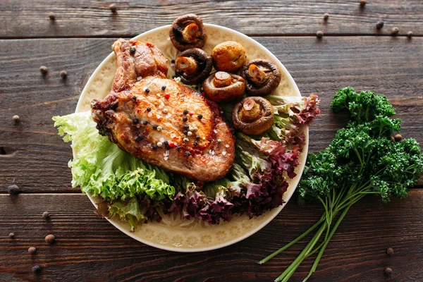 Grilled pork dish with lettuce and mushrooms