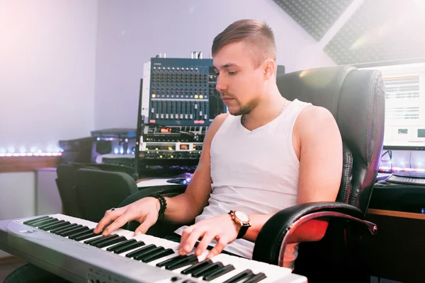 DJ plays on electronic piano in the studio
