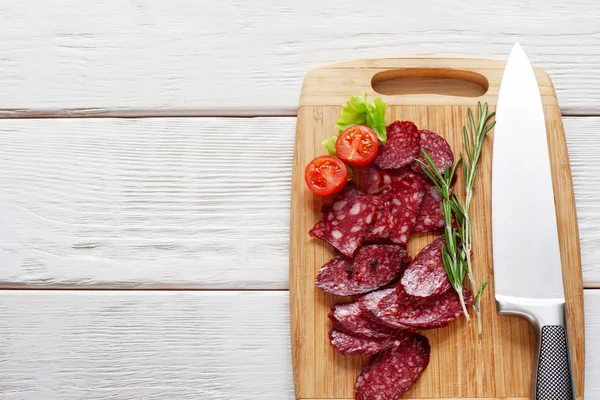 Cutting board with sliced sausage copyspace