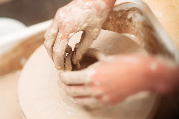 Making ceramics pot dirty hands close-up