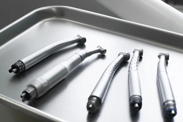 Dental turbine handpieces on metal tray closeup