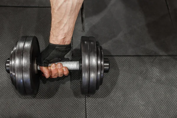 Male athlete hand start training with dumbbell