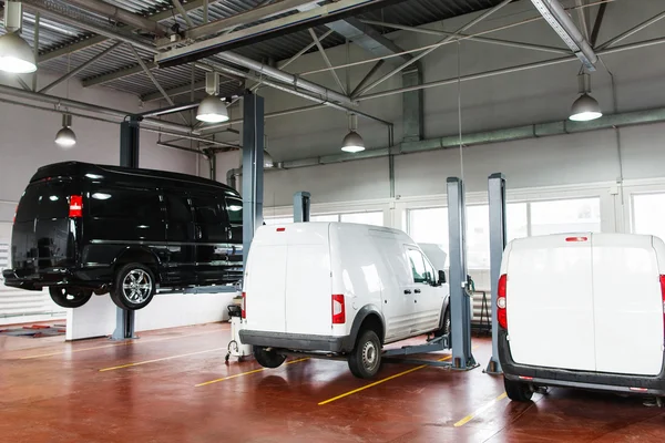 SUV service station, minibus raised up on lift