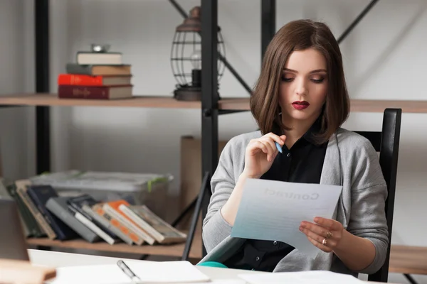Young businesswoman working on business papers