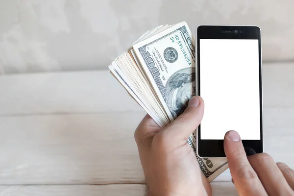 Hand holding smartphone and dollars, mockup