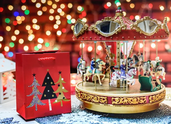 Merry Go Round music decoration and Christmas present in the red bag