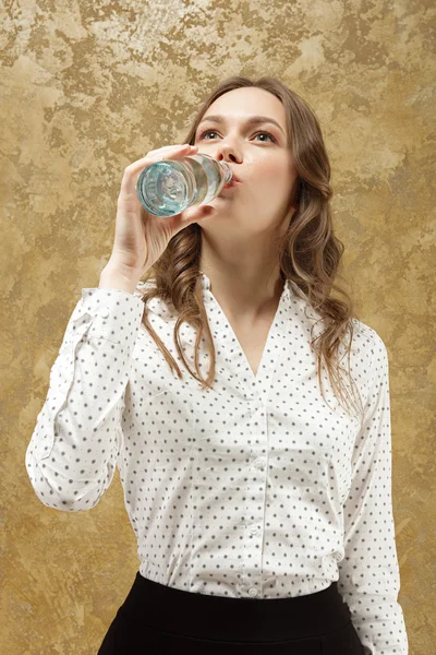 Attractive girl with bottle of water in hand