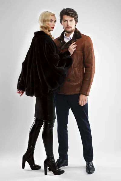 Stylish man and glamour woman in fur coat posing