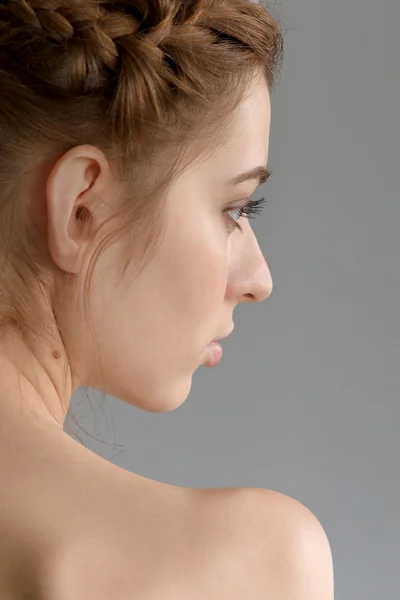 Portrait of young lady with red hair in profile