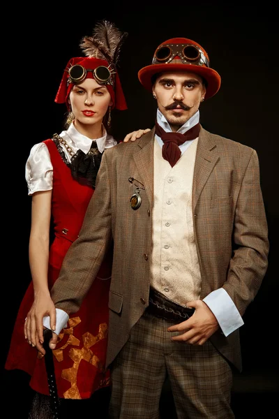 Portrait of steampunk girl and man in glasses and cane