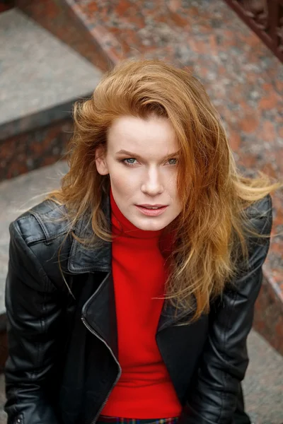 Portrait of red hair lady in leather jacket with cardboard cup
