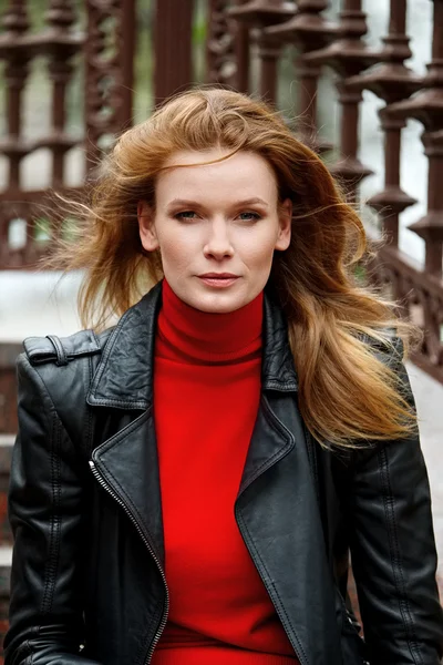 Portrait of red hair lady in leather jacket with cardboard cup
