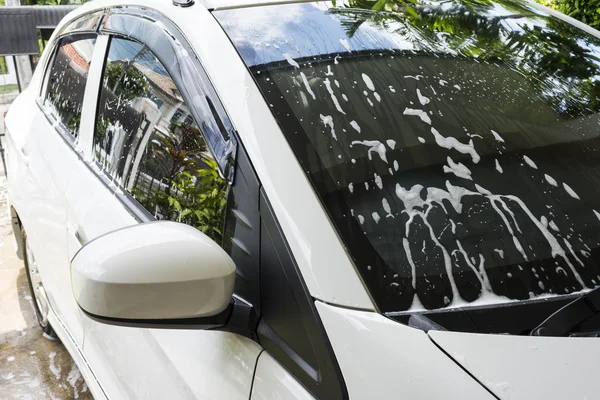 Soap bubbles on car window before car wash