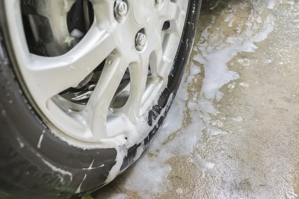 Soap bubbles on wheel before car wash