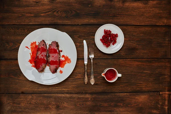 Two fried steak lie on a large white plate