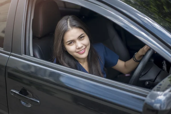 Attractive business woman driving her car