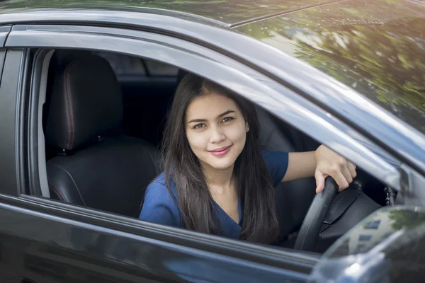 Attractive business woman driving her car