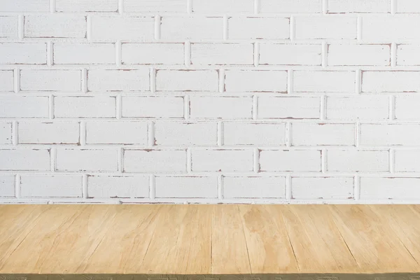 Wood floor with background of grunge white brick wall