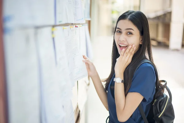 A female university student is exciting with the exam report