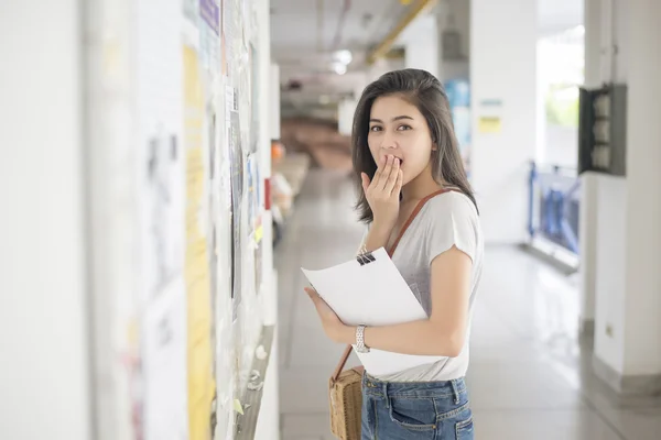 A female university student is exciting with the exam report