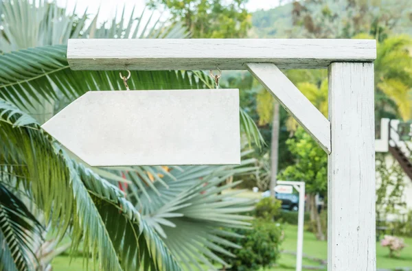 White wood label in the garden background